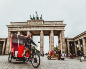 Man in Black Hoodie Riding Trike to explore in Berlin