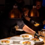 what to eat in Berlin - a couple of men sitting at a table with plates of food