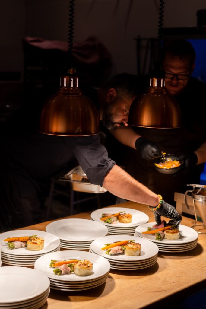 what to eat in Berlin - a couple of men sitting at a table with plates of food