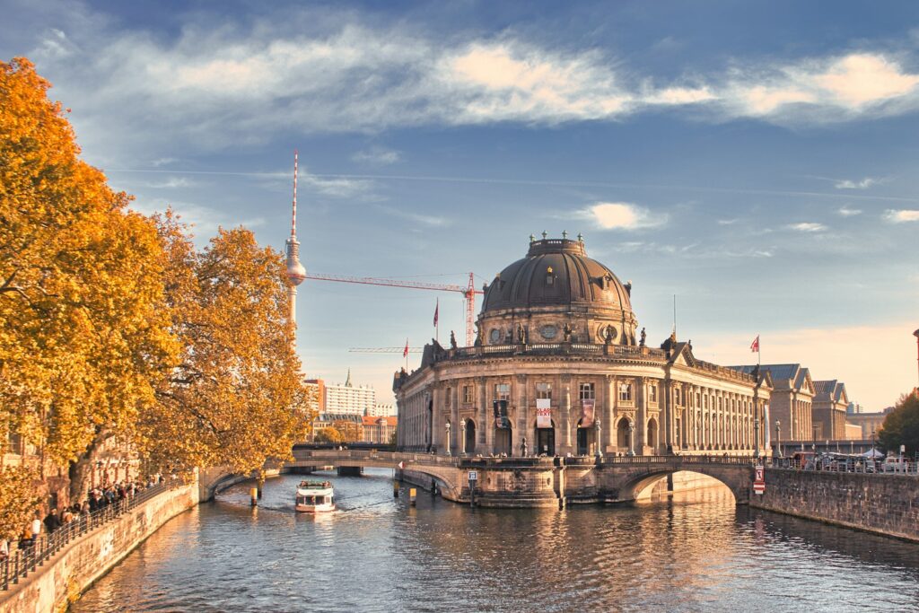 a large building sitting on the side of a river