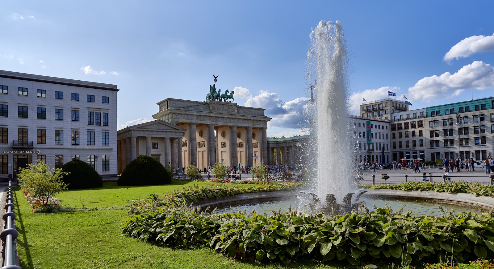 Discover the best accommodations in Berlin! Explore our guide on where to stay in Berlin for an unforgettable trip. Book now! - a fountain in the middle of a park with buildings in the background