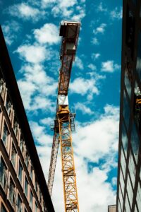 orange metal crane under blue sky during daytime