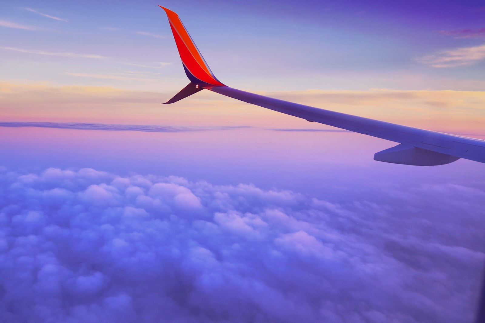 Book your Flight to Berlin now and embark on an unforgettable adventure in the vibrant capital of Germany. Don't miss out! - person in a plane flying at high altitude taking photo of left airplane wing during daytime